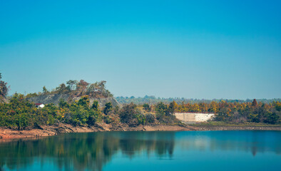 Obraz premium serene waterscape of large lake created for Purulia pumped storage project (upper dam) in the vicinity of Ajodhya Hills. The lake is also the major source of water in arid regions of Purulia.
