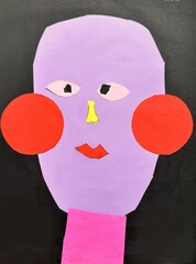 Abstract collage art of a face with red cheeks, purple face, and yellow nose. The child artwork is vibrant and imaginative.