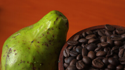 avocado and coffee beans on a brown wooden table. Photo for advertising © amrisyam
