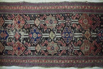 An antique carpet on the wall. Caucasian folk crafts and art