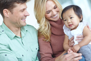 Happy family, parents and adopted baby in home for custody, support and bonding together. Mother,...