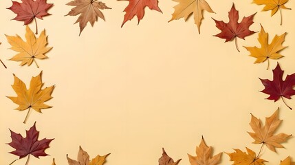 Obraz premium Top view of dry maple autumn leaves on pastel yellow background with ample copy space for text