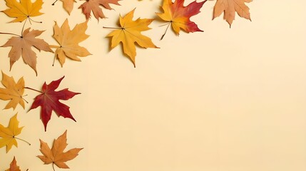 Top view of dry maple autumn leaves on pastel yellow background with ample copy space for text