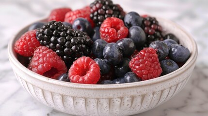 A bowl of mixed berries including raspberries, blackberries, and blueberries.