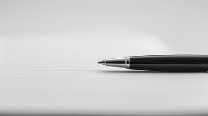 Close-up of a minimalistic black pen resting on a blank notebook page, emphasizing simplicity and elegance in design