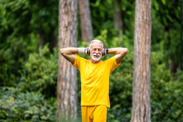 Happy senior man enjoying physical exercise in the park. Healthy lifestyle.