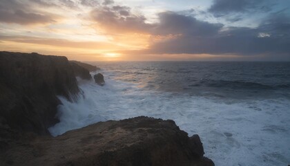 Beautiful colorful sunset and vivid dramatic sky at rocky shore of the Atlantic ocean.