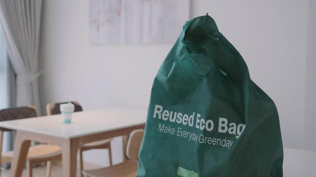 A green bag that says Reused Eco Bag on it