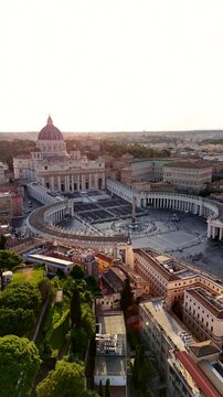 Aerial shot of the dwarf Vatican City state in Rome, Italy. Top view of St. Peter's Square in Vatican City at sunset. Vertical video