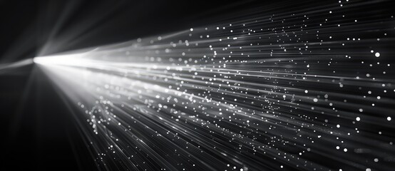 White light rays of a laser beam on a black background, an abstract technology concept