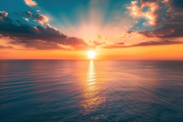 Fototapeta premium Beautiful sunset over the sea with orange sky and sun reflecting on water