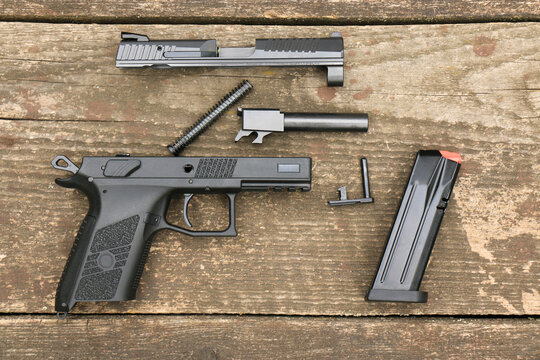 A modern automatic pistol disassembled into its basic elements, prepared for cleaning. Right side.