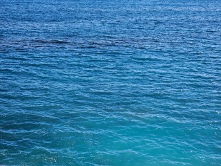 Genova, Italy, April 19, 2024. Scenic views of Genova Nervi from the coastal promenade, Liguria, Italy. Beautiful sunny day with blue sky reflected over the sea. Mediterranean rocky coastline village