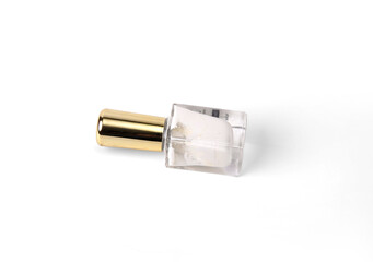 Closeup Photo Of A Used White Nail Polish Bottle With A Shiny Golden Cap On White Background