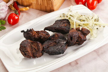 Grilled beef barbecue served onion