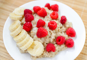 Oatmeal with pieces of raspberry and banana
