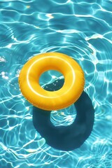 Top view of yellow pool ring floating on water with blue background in swimming pool in sunshine. A life belt floats in the sea.