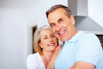 Senior, couple and man with portrait in kitchen for bonding, embrace and happy with retirement in home. Elderly, people and face with hugging, relax and support in marriage with romance in house