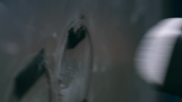 Drummer strikes bass drum beater sending deep resonant thud closeup. 
