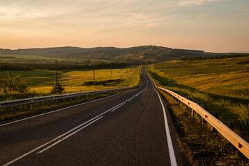 empty road in the mountains at sunset