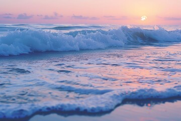Obraz premium Soft, pastel-colored sunset over a serene ocean with gentle waves crashing on the shore.