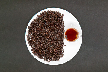 Espresso Americano in a glass cup with fresh coffee beans scattered around Isolated White Background