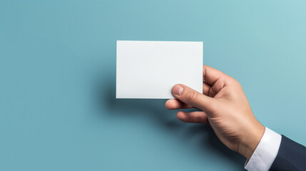 Obraz premium Middle shot of a person wearing business suit and holding a blank white paper little banner mockup