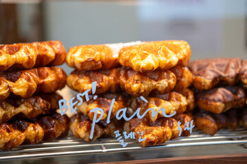 Croffle, a hybrid of a croissant and waffle which is a popular pastry in South Korea, in the display with Korean text 'plain'