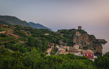 Fototapeta na wymiar Cliffs on the coast in summer in Scopello near of Castellammare del Golfo in Sicily, Italy. June 2023, long exposure picture, sunrise time.