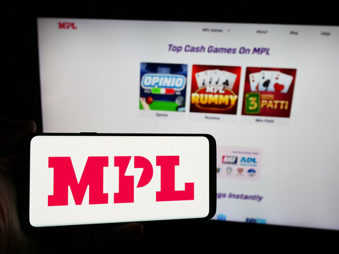Stuttgart, Germany - 07-14-2024: Person holding smartphone with logo of Indian online gaming company Mobile Premier League (MPL) in front of website. Focus on phone display.