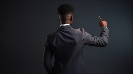 young black businessman back view, hand on hip, pointing with other hand to an object in the distance, somewhere far-off