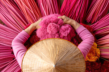 Vietnam incense preparation for New Year celebrations, Incense sticks drying outdoor with Vietnamese woman wearing conical hat in Hanoi, Vietnam