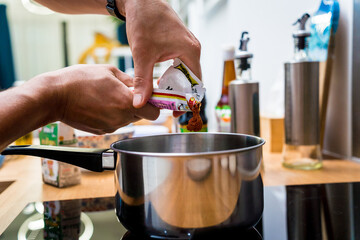 Chef at the kitchen preparing massaman curry with sweet potato and many spices