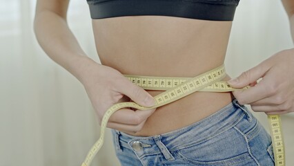 Woman measuring perfect shape of beautiful waist, healthy lifestyles concept.