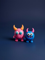 Obraz premium Two plasticine monsters, pink and blue