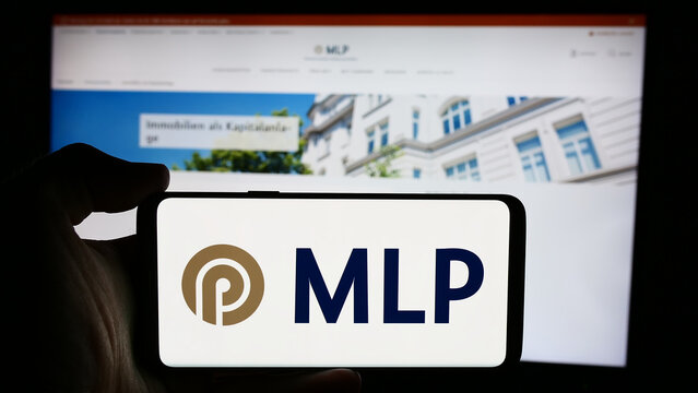 Stuttgart, Germany - 07-15-2024: Person holding cellphone with logo of German financial services company MLP SE in front of business webpage. Focus on phone display.