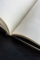A close-up shot of an open book lying on a table, with pages folded and words visible