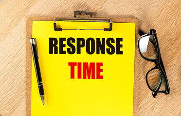 RESPONSE TIME text on yellow paper on clipboard with pen and glasses