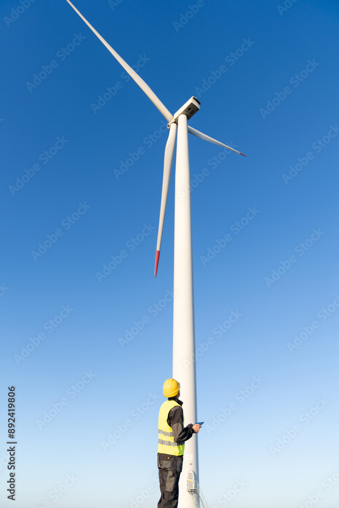 Aufkleber engineer with digital tablet controls wind turbines