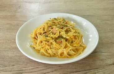 fried spaghetti slice ham pork with chop garlic in carbonara cheese cream sauce on plate   