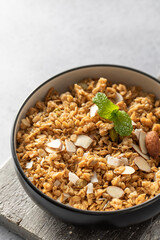 Crispy homemade granola with sliced almonds in a bowl. Healthy food