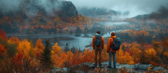 Fototapeta premium Two Hikers Admire the Autumnal Landscape