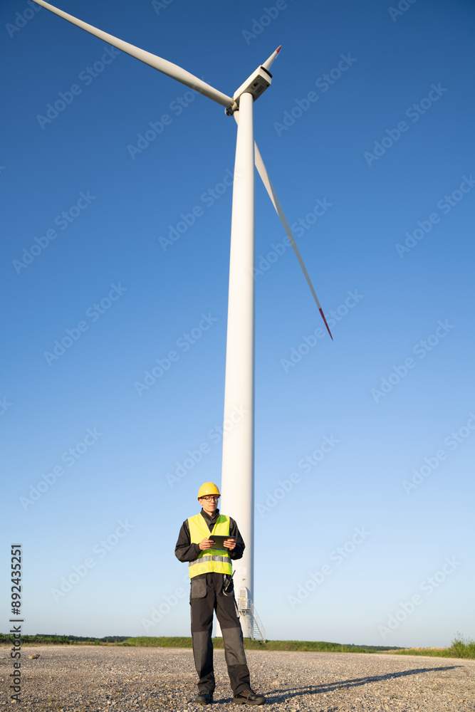 Aufkleber engineer with digital tablet controls wind turbines