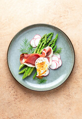 Asparagus and poached eggs with jamon and fresh dill