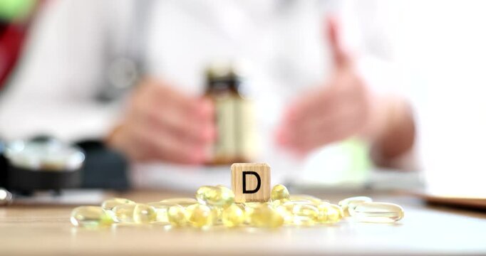 Doctor prescribing yellow gelatin capsules of vitamin d 4k movie slow motion. Rickets prevention concept
