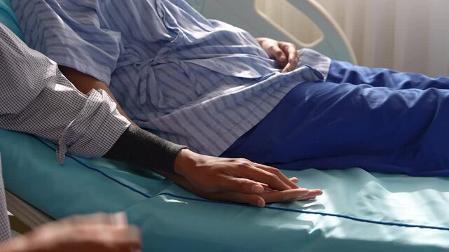 Asian patient female and male listen to doctor in hospital room. husband holding hand wife focused on examination results, health care support medical examination, professional services business