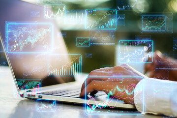 A person analyzing financial data on a laptop with digital graphs overlaid, showcasing a concept of modern finance analysis