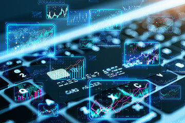 Digital financial charts overlaid on a computer keyboard with a dynamic blue background, symbolizing technological finance analysis