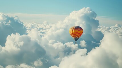 Fototapeta premium A hot air balloon floats among fluffy clouds, the vibrant colors of the balloon contrasting with the soft white of the clouds.