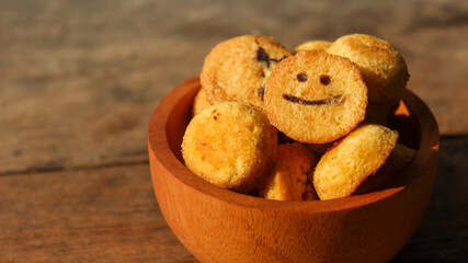 Kue bolu kering or Dried sponge cake in a small wooden bowl with wooden background